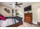 Bedroom featuring a ceiling fan and dresser with a large tv and accents at 1236 Country Pine Dr, Ellenwood, GA 30294