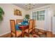 Dining room with seating for six, chandelier lighting, and a beautiful flower-patterned rug at 1236 Country Pine Dr, Ellenwood, GA 30294