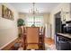Dining room with seating for six, chandelier lighting, and hardwood flooring at 1236 Country Pine Dr, Ellenwood, GA 30294