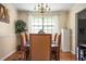 Dining room with seating for six, chandelier lighting, and hardwood flooring at 1236 Country Pine Dr, Ellenwood, GA 30294