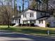 Charming two-story home with manicured lawn, black shutters, and attached two-car garage at 1236 Country Pine Dr, Ellenwood, GA 30294