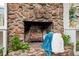 Cozy stone fireplace with a rustic hearth, complemented by greenery and warm accents at 1236 Country Pine Dr, Ellenwood, GA 30294