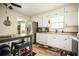 Bright kitchen with white cabinets, stainless steel appliances, and an eat-in dining area at 1236 Country Pine Dr, Ellenwood, GA 30294