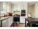 Functional kitchen featuring stainless steel appliances, white cabinets, and a casual dining setup at 1236 Country Pine Dr, Ellenwood, GA 30294