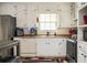 Well-equipped kitchen with modern appliances, ample counter space, and charming white cabinetry at 1236 Country Pine Dr, Ellenwood, GA 30294