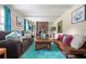 Bright living room featuring two sofas, a stone fireplace, and large windows for natural light at 1236 Country Pine Dr, Ellenwood, GA 30294