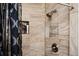 Elegant shower features neutral marble tile, a sleek shower head, and a convenient built-in storage nook at 1236 Country Pine Dr, Ellenwood, GA 30294