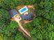 Aerial view of a private home on acreage surrounded by lush green trees at 160 Cross Rd, Covington, GA 30016