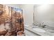 Bathroom with nature-themed decor features granite counters, a large vanity, and a shower at 160 Cross Rd, Covington, GA 30016