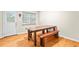 Bright dining room with hardwood floors, long wooden table and rustic bench seating at 160 Cross Rd, Covington, GA 30016