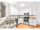 Bright kitchen with white cabinets, stainless steel appliances, granite counters, and a stainless steel sink at 160 Cross Rd, Covington, GA 30016