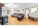 Spacious living room featuring hardwood floors, comfortable seating, and a view into the kitchen at 160 Cross Rd, Covington, GA 30016