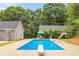 The backyard features a sparkling blue pool with diving board and slide at 160 Cross Rd, Covington, GA 30016