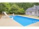 View of a beautiful inground pool with basketball hoop and slide at 160 Cross Rd, Covington, GA 30016