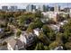 Overhead view showing a residential neighborhood with lush trees and views of city skyline at 2941 Lookout Ne Pl, Atlanta, GA 30305