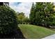 Manicured backyard lawn with lush landscaping and mature trees at 2941 Lookout Ne Pl, Atlanta, GA 30305