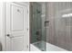 Tiled bathroom featuring a shower-over-tub combination and glass enclosure, promoting cleanliness at 2941 Lookout Ne Pl, Atlanta, GA 30305