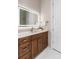 Bathroom vanity with wood cabinetry, stone countertop, and large, lit mirror at 2941 Lookout Ne Pl, Atlanta, GA 30305