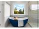 Bathroom features a soaking tub with a view, and a glass-enclosed shower at 2941 Lookout Ne Pl, Atlanta, GA 30305
