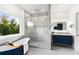 Bathroom with large window, soaking tub, and glass enclosed shower at 2941 Lookout Ne Pl, Atlanta, GA 30305
