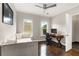Charming bedroom with a daybed, desk, hardwood floors, and natural light from two windows at 2941 Lookout Ne Pl, Atlanta, GA 30305