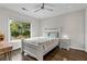 Bedroom featuring hardwood floors, a ceiling fan, and a window overlooking the neighborhood at 2941 Lookout Ne Pl, Atlanta, GA 30305