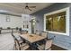 This patio deck has a dining table and chair set with grill and part of a white building in view at 2941 Lookout Ne Pl, Atlanta, GA 30305