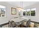 Bright dining room with modern light fixture, large windows, hardwood floors, and seating for six at 2941 Lookout Ne Pl, Atlanta, GA 30305