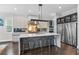 Bright kitchen features stainless steel appliances, a large island with seating and stone backsplash at 2941 Lookout Ne Pl, Atlanta, GA 30305