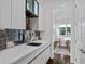 Kitchen with modern cabinets, backsplash, stainless steel faucet, and hardwood floors leading into dining area at 2941 Lookout Ne Pl, Atlanta, GA 30305