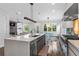 Open-concept kitchen featuring stainless steel appliances, large island, and view into the living and dining areas at 2941 Lookout Ne Pl, Atlanta, GA 30305