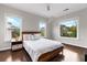 Bright main bedroom with hardwood floors, ceiling fan, and two windows with neighborhood views at 2941 Lookout Ne Pl, Atlanta, GA 30305