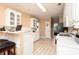 Bright kitchen with white cabinets, white appliances and a breakfast bar at 210 Huiet Dr, Mcdonough, GA 30252