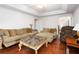 Bright living room with hardwood floors and comfortable seating at 210 Huiet Dr, Mcdonough, GA 30252