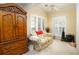 Comfortable living room with natural light, ceiling fan, and a classic armoire at 210 Huiet Dr, Mcdonough, GA 30252