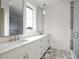 Bright bathroom features marble counters, dual sinks, and an enclosed shower at 10939 Serenbe Ln, Chattahoochee Hills, GA 30268