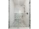Enclosed shower featuring white tiles, marble accents, and modern fixtures at 10939 Serenbe Ln, Chattahoochee Hills, GA 30268
