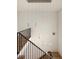 Stylish staircase with modern hanging light fixture and black metal railing at 10939 Serenbe Ln, Chattahoochee Hills, GA 30268