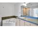 Primary bathroom showcasing dual sinks, a soaking tub, and a glass-enclosed shower at 285 Centennial Olympic Park Nw Dr # 903, Atlanta, GA 30313