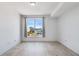 Spacious bedroom with wood-look floors, white walls, and a large window with a scenic view at 285 Centennial Olympic Park Nw Dr # 903, Atlanta, GA 30313