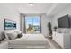Staged bedroom featuring a comfortable bed, city views, and modern decor at 285 Centennial Olympic Park Nw Dr # 903, Atlanta, GA 30313