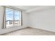 Minimalist bedroom with natural light from a large window and wood-look floors at 285 Centennial Olympic Park Nw Dr # 903, Atlanta, GA 30313