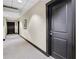 Hallway with neutral walls, dark trim, and carpet leading to apartments, enhancing the sophisticated ambiance of the building at 285 Centennial Olympic Park Nw Dr # 903, Atlanta, GA 30313