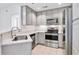 Modern kitchen featuring stainless steel appliances, light gray cabinets, and quartz countertops, seamlessly blending style and functionality at 285 Centennial Olympic Park Nw Dr # 903, Atlanta, GA 30313