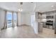 Bright living room with hardwood floors, balcony access, and a modern kitchen, perfect for entertaining and relaxing at 285 Centennial Olympic Park Nw Dr # 903, Atlanta, GA 30313