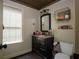 Bathroom with dark vanity, tile flooring, and window at 503 Mary Margaret Walk, Loganville, GA 30052