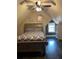 Bedroom with dark wood flooring, a ceiling fan, and a queen-sized bed at 503 Mary Margaret Walk, Loganville, GA 30052