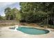 Relaxing kidney-shaped pool surrounded by trees and a wooden fence at 503 Mary Margaret Walk, Loganville, GA 30052