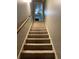 Carpeted staircase with wooden handrail leading to upper level at 503 Mary Margaret Walk, Loganville, GA 30052