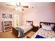 Two twin beds in a spacious bedroom with colorful bedding and built-in shelving at 160 Edgewater Trl, Fayetteville, GA 30215